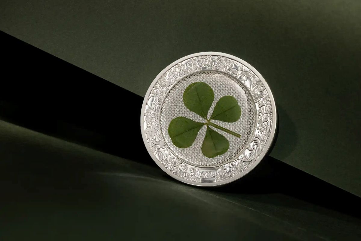 Shiny silver coin featuring a four-leaf clover, 2026 Cook Islands, 1 oz weight, minted by GR, with colorful design,.