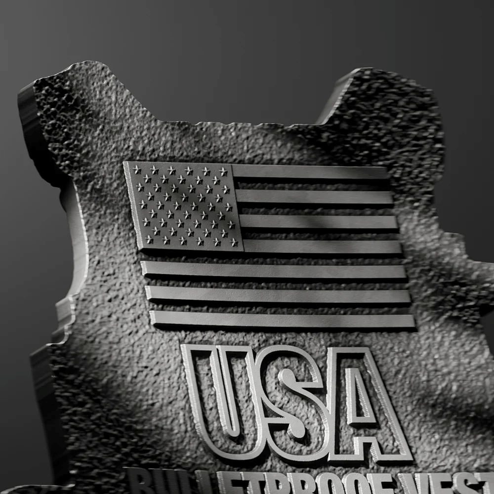 Close-up of 2026 US Bulletproof Vest 2 oz Silver collectible, shaped with American flag and USA inscription, minted.