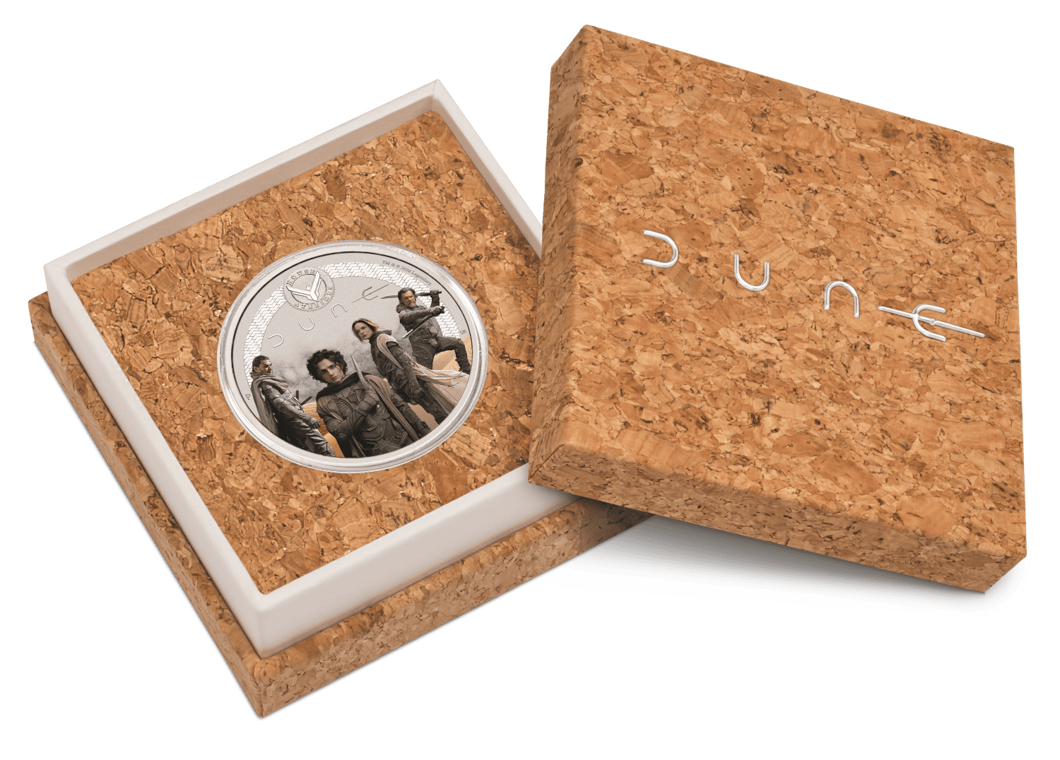 Open cork-textured presentation box with the colorized coin seated in a white insert beside the Dune-branded lid