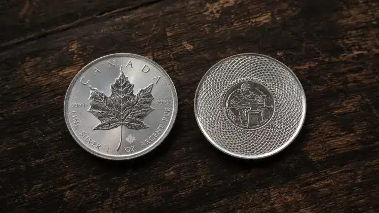 Sovereign coin and private mint silver round side by side on dark walnut, showing mint mark details