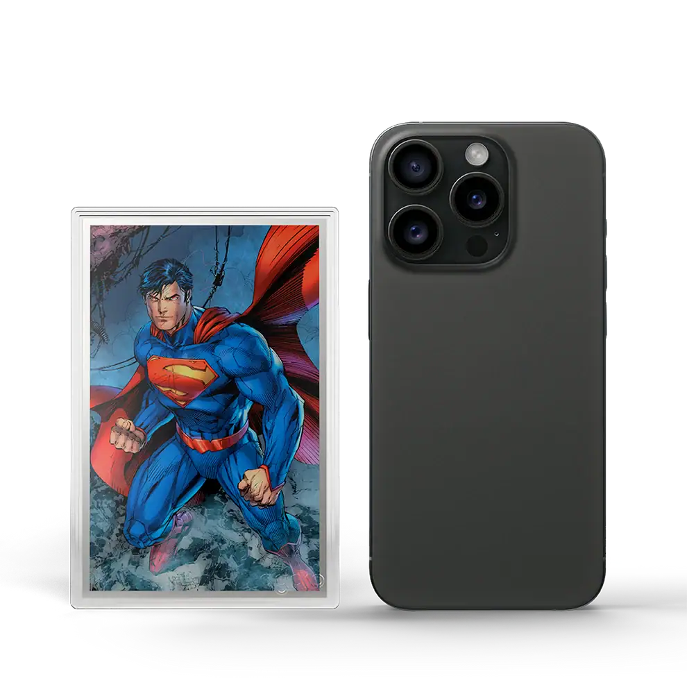 Agoro DC Trinity 5g silver foil in capsule beside a smartphone, colorized Superman with a red cape